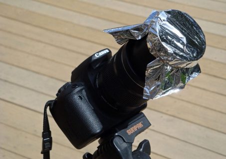 An easy solar filter: Baader AstroSolar Safety Film OD 5.0 over a camera lens and held in place with elastic bands (Photo by Paul Deans/TQ).